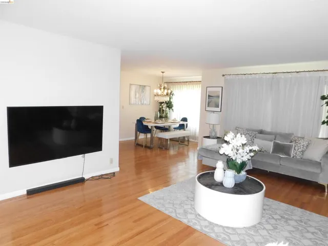 Open-concept living space featuring wood-finish flooring