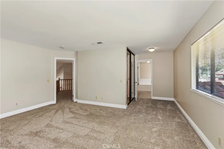 Large Hallway leading to Primary in-suite Bathroom