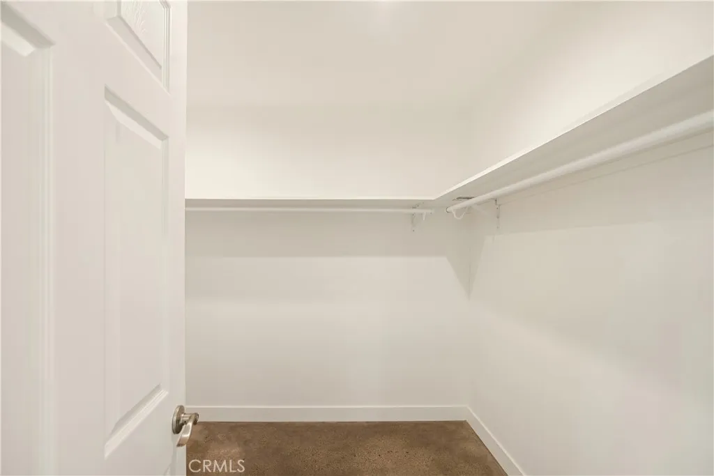 Primary bedroom walk in closet