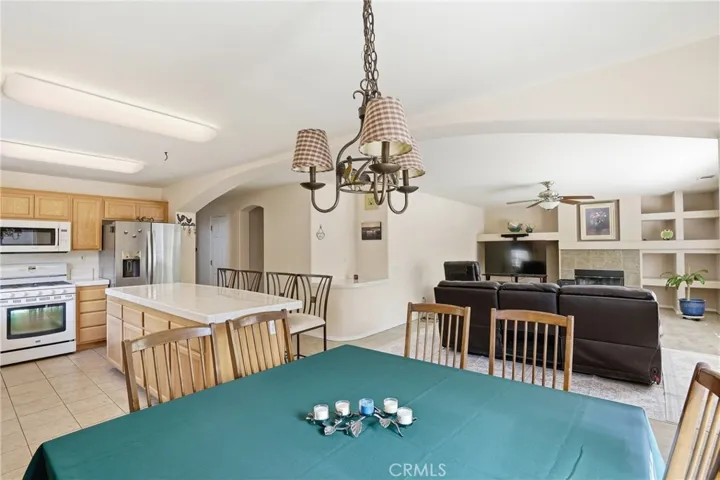 Dining Area With Back Family Room And Kitchen In Background