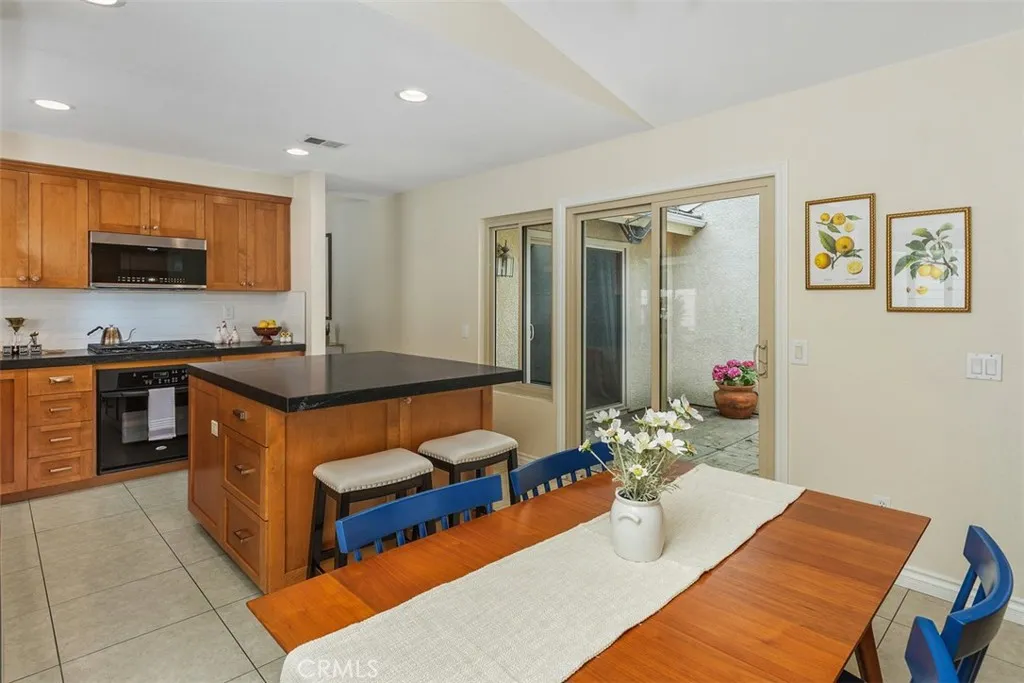 Open Kitchen Dining Area Island has room for Sit Up Stools...Lots of Light with Atrium Sliders