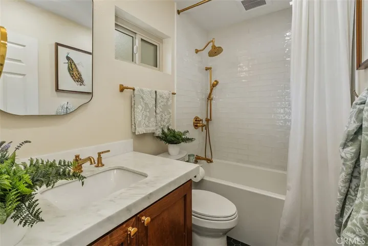 Beautifull Remodeled Bathroom with Gold Designer Touches  Tub Shower Combo Marble Counter and Tile Flooring