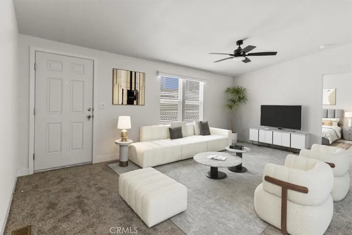 Kitchen opening to living area virtually staged photo with furniture