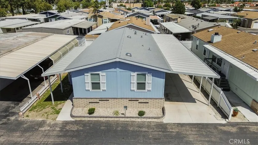 Drone View: Aerial perspective of the home’s location within Lincoln Center Mobile Home Park, an all-age Cypress community near local amenities, shopping, dining, entertainment, and convenient freeway access.