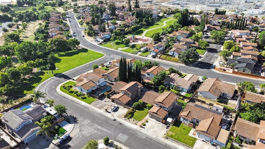 Established residential area featuring a curvilinear street layout and a central green space