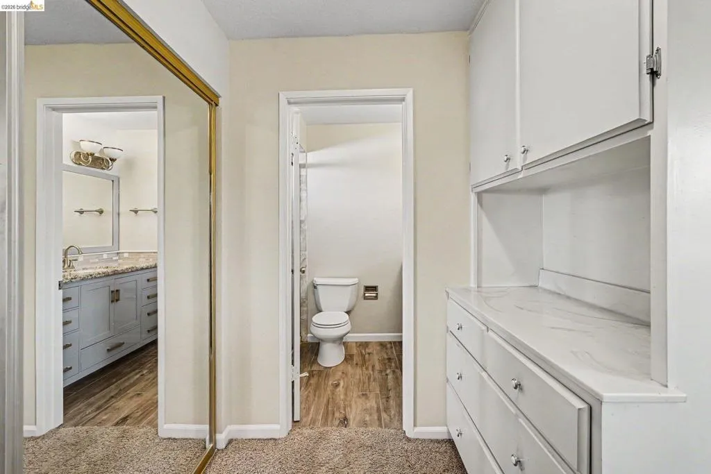 Hallway with built-in cabinetry, white countertops, and brushed nickel hardware
