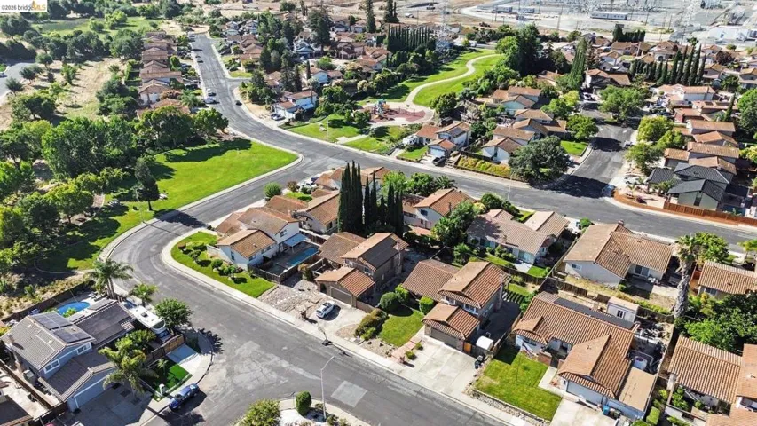 Established residential area featuring a curvilinear street layout and a central green space