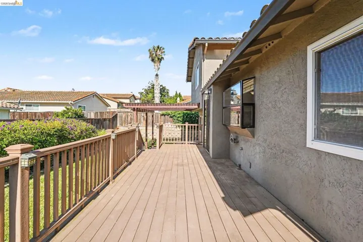 Spacious outdoor deck featuring composite decking and a pergola structure