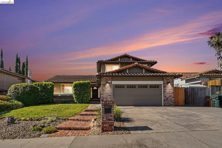 Two-story exterior with a tile roof and brick accents