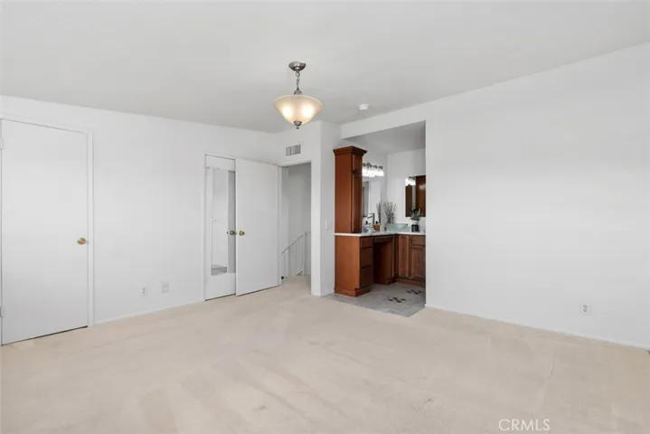 PRIMARY BED AND BATH + HIS & HERS WALK-IN CLOSETS