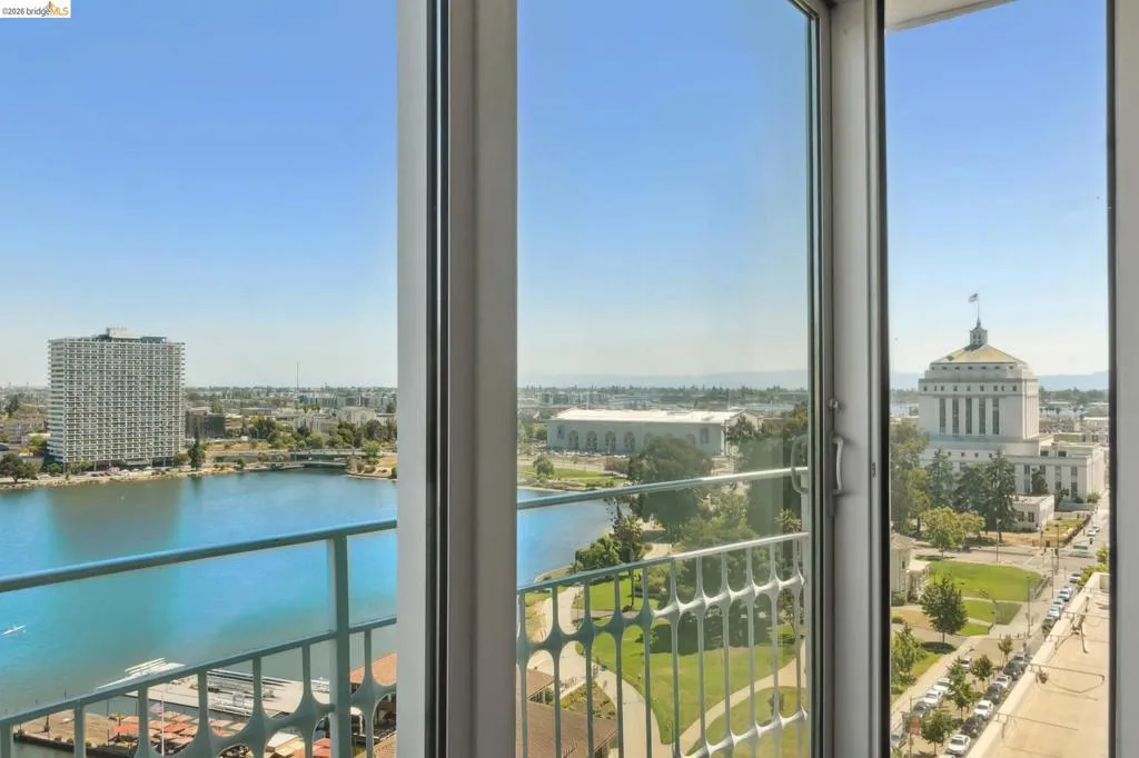 Balcony with a water view and a view of city