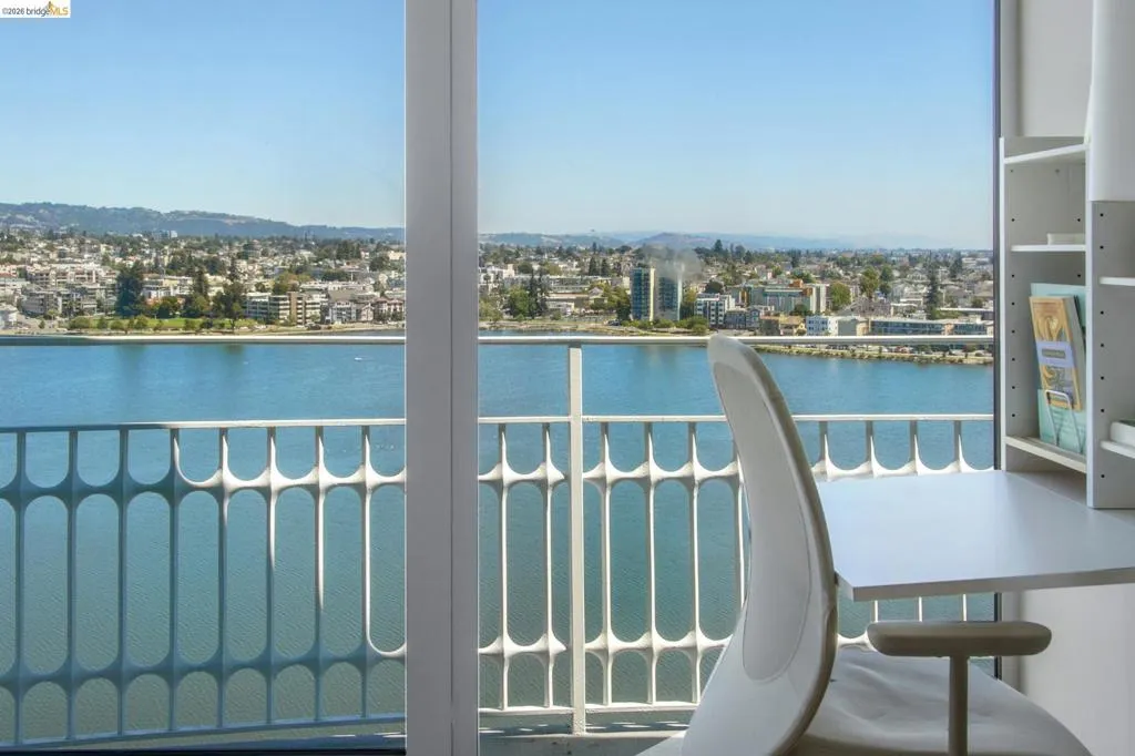 Balcony featuring a water view and a view of city