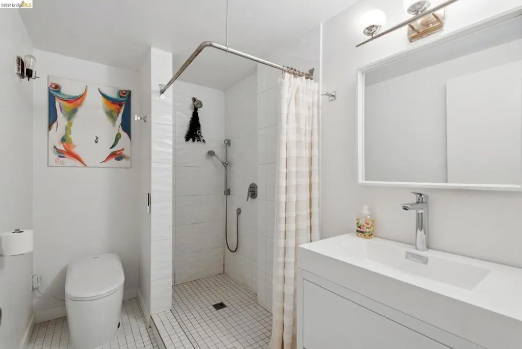 Bathroom featuring vanity, a stall shower, and light tile patterned floors