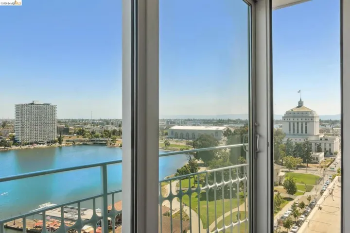 Balcony with a water view and a view of city