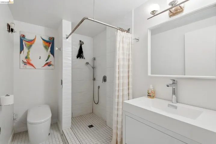 Bathroom featuring vanity, a stall shower, and light tile patterned floors