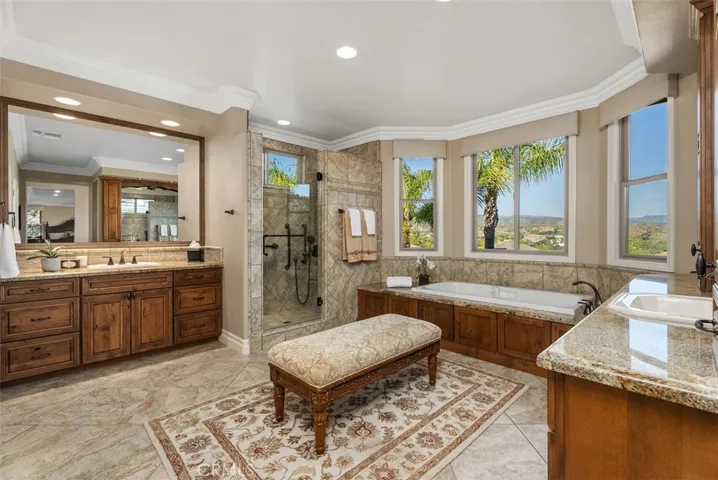Primary Bathroom with Dual Sinks, Soaking Tub, and Two Walk-in Closets
