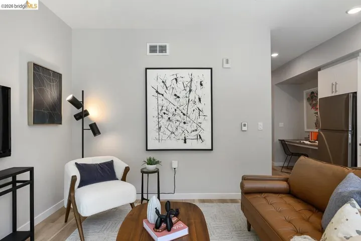 Living room with light wood finished floors and recessed lighting