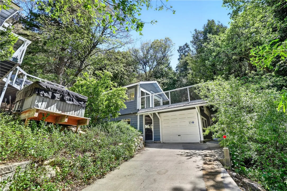 ADU with private deck above, detached single car garage and workshop below
