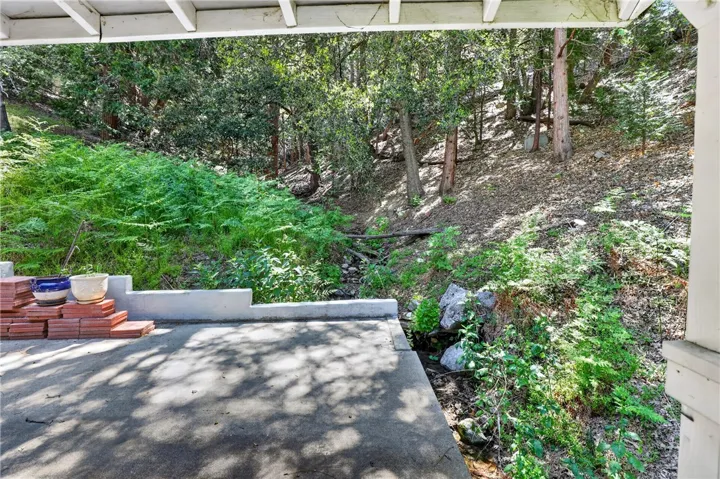 Manicured paths, seasonal stream, and gardens surround the home
