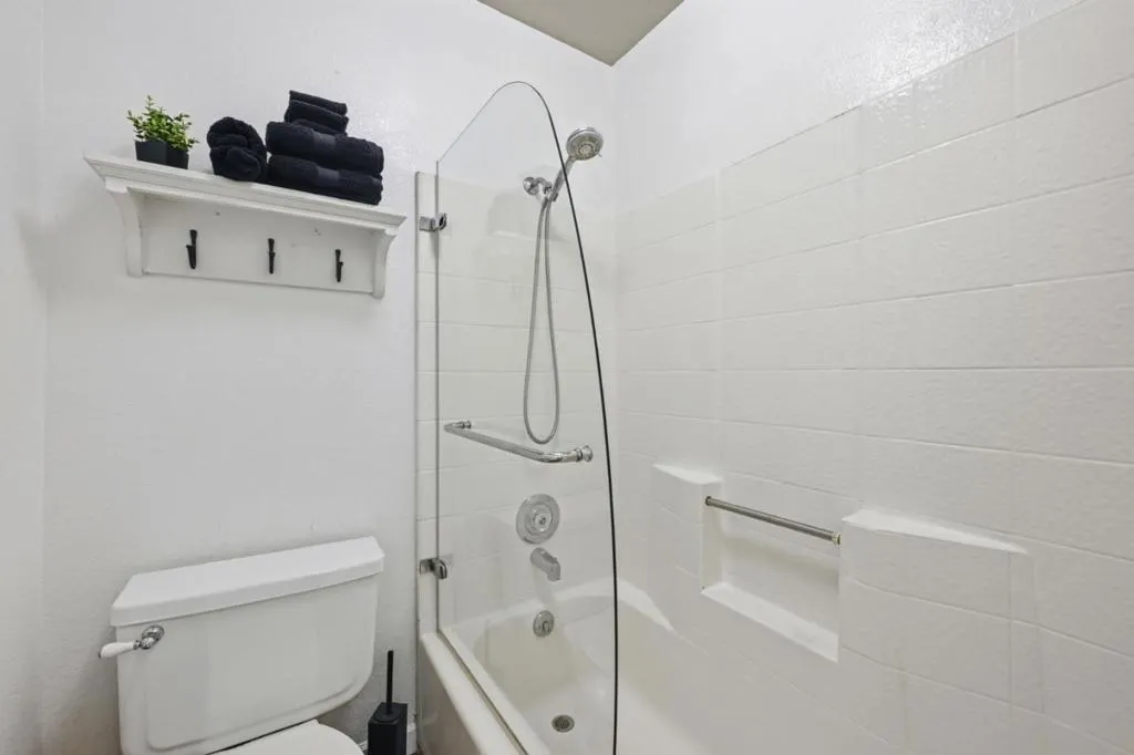 Shower over tub in top floor Bathroom.