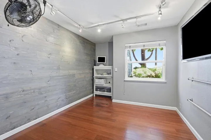 Bedroom 2 on bottom floor being used as workout/rec room.