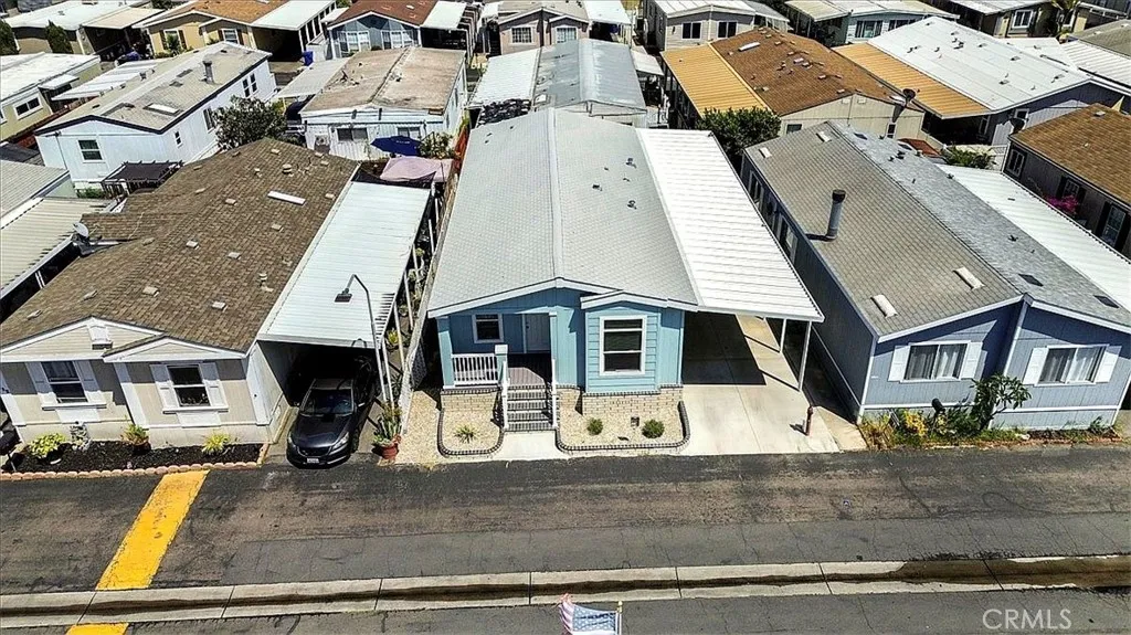 Drone View: Aerial perspective of the home’s location within Lincoln Center Mobile Home Park, an all-age Cypress community near local amenities, shopping, dining, entertainment, and convenient freeway access.