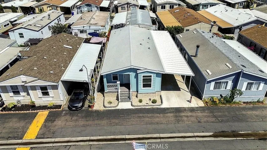 Drone View: Aerial perspective of the home’s location within Lincoln Center Mobile Home Park, an all-age Cypress community near local amenities, shopping, dining, entertainment, and convenient freeway access.