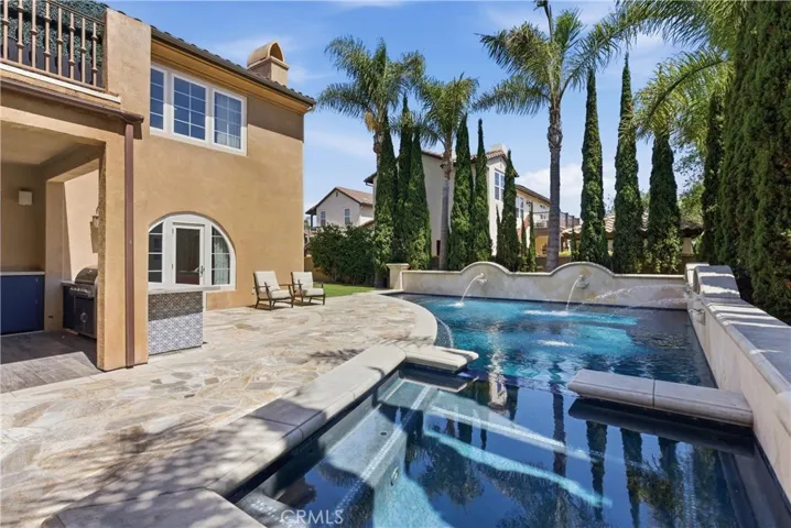 Framed by lush landscaping and hillside views, the backyard creates a private retreat ideal for everything from relaxed mornings to unforgettable evenings under the stars.
