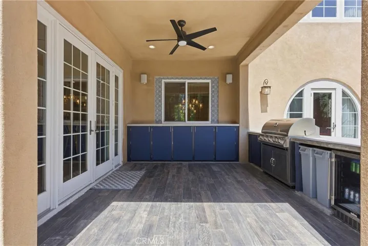 Built-in outdoor kitchen and entertaining patio seamlessly connected to the indoor kitchen and family room, creating effortless indoor-outdoor living ideal for gatherings and everyday entertaining.