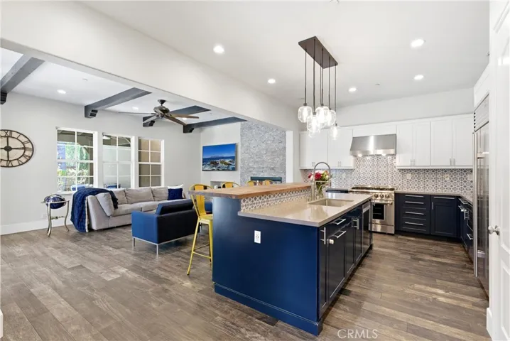 Custom chef’s kitchen with farmhouse-inspired butcher block island, prep sink, stainless steel appliances, recessed lighting, and abundant storage.