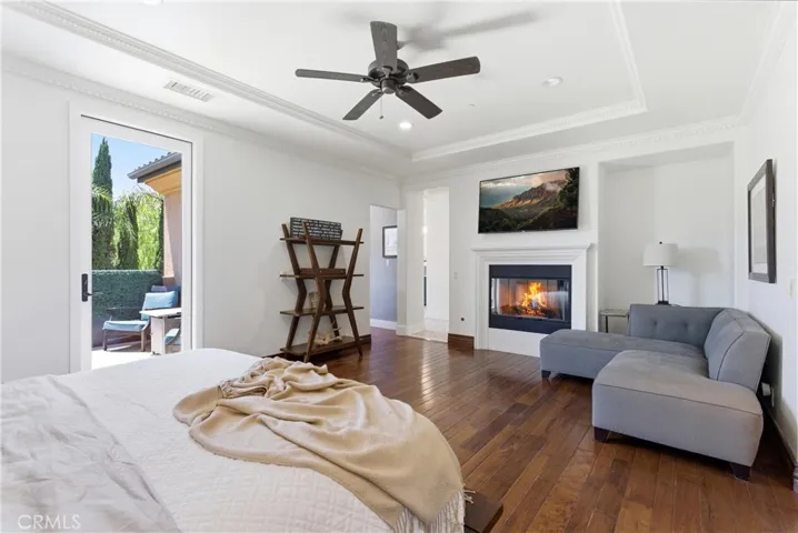 Private primary balcony offers a peaceful outdoor escape surrounded by mature landscaping and scenic hillside backdrops.