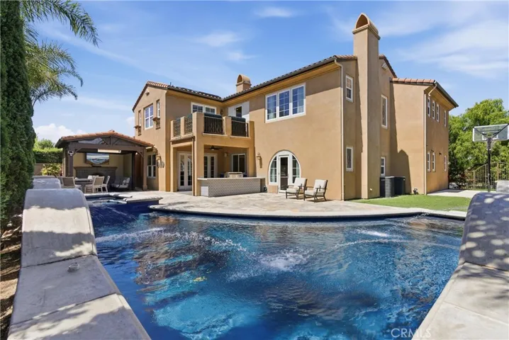 Multiple outdoor entertaining spaces designed for dining, relaxing, and year-round gatherings