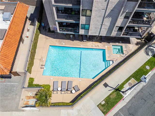 Amenities include an inviting pool deck, pool and spa.