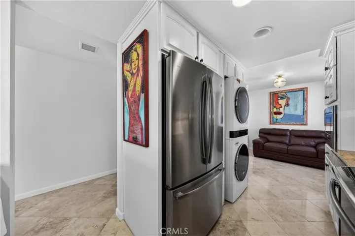 Fridge and washer/dryer share the other kitchen wall.