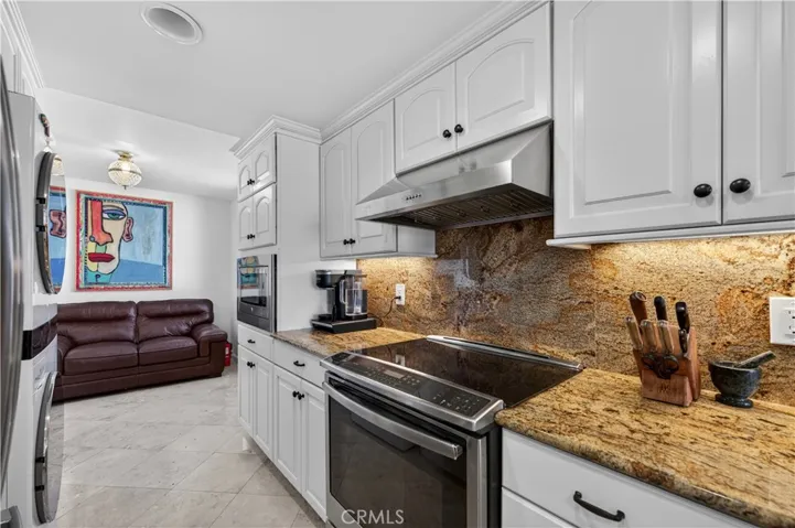 Range, hood and built-in microwave share one wall of the kitchen.