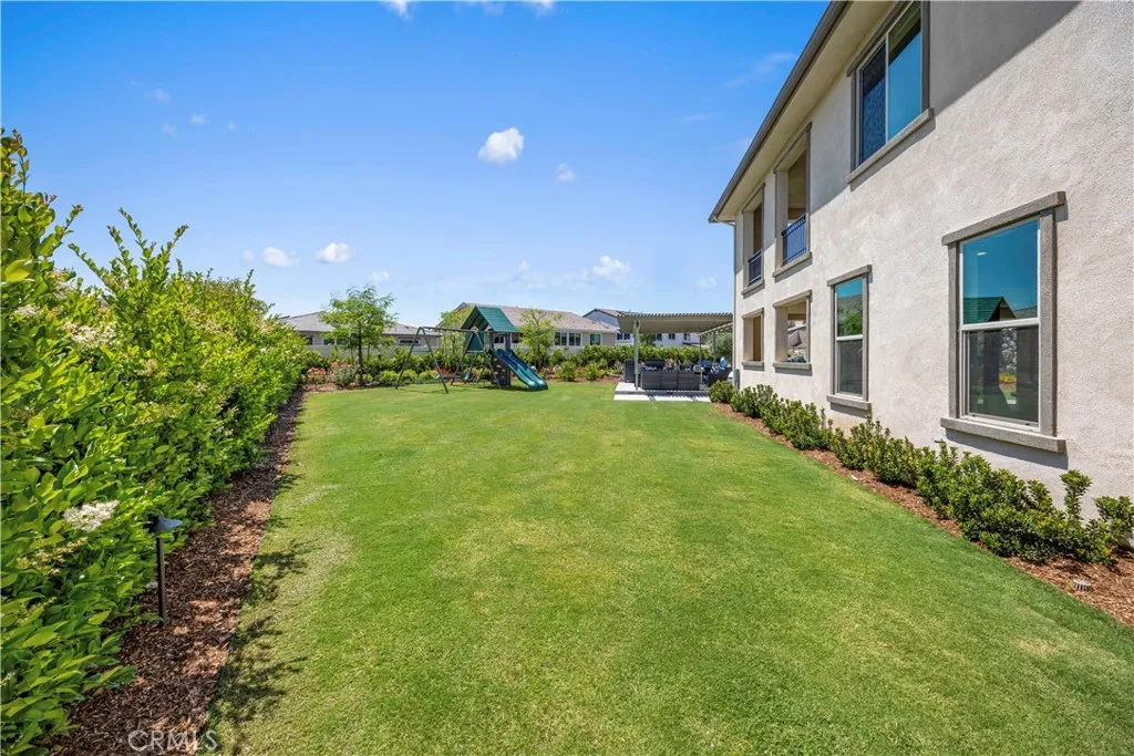 Oversized side yard with Bermuda grass and Playset