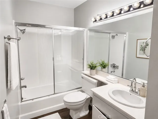 Your basthroom with lots of shelves behind the door/ tub/shower