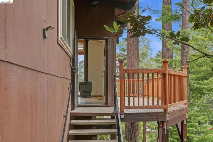 Exterior wood siding with a private wood deck and natural wood railing