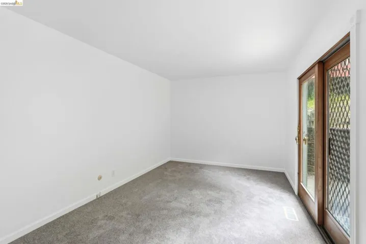 Interior room featuring light gray carpeting and white painted walls