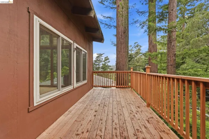 Expansive outdoor deck with natural wood flooring and railing