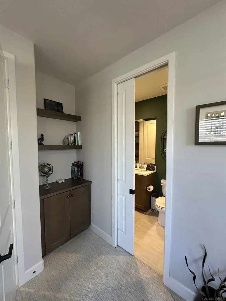 1st floor full bathroom with pocket-door connecting to guest bedroom