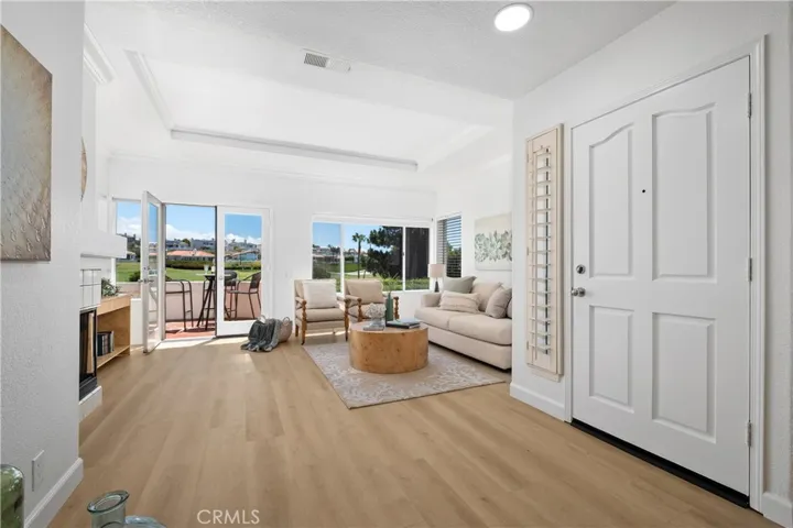 Freshly painted and featuring new luxury vinyl plank flooring throughout, this light-filled home offers an open-concept floor plan designed for comfortable coastal living. Abundant natural light enhances the spacious living areas, creating a bright and inviting atmosphere perfect for both everyday living and entertaining.