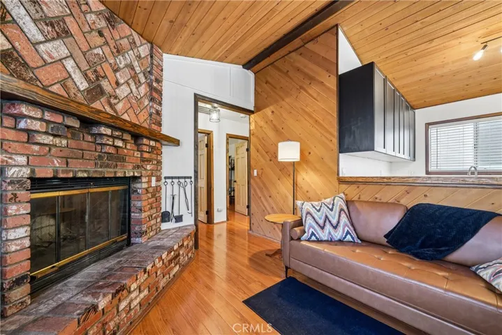 Cozy fireside living space with custom wood details and open connection to the kitchen.