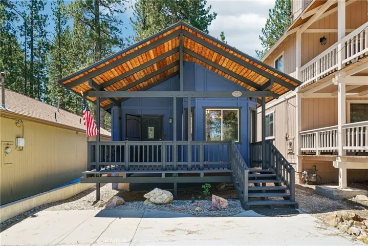 Big Bear Lake home with inviting front elevation, covered entry deck, and level parking.