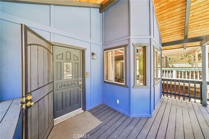 Covered front deck with protected entry and space to enjoy morning coffee.