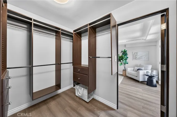 Walk-in closet with ample built-ins.