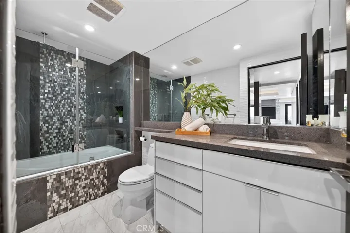 Hallway bath with incredible tile work in the shower/tub combo.