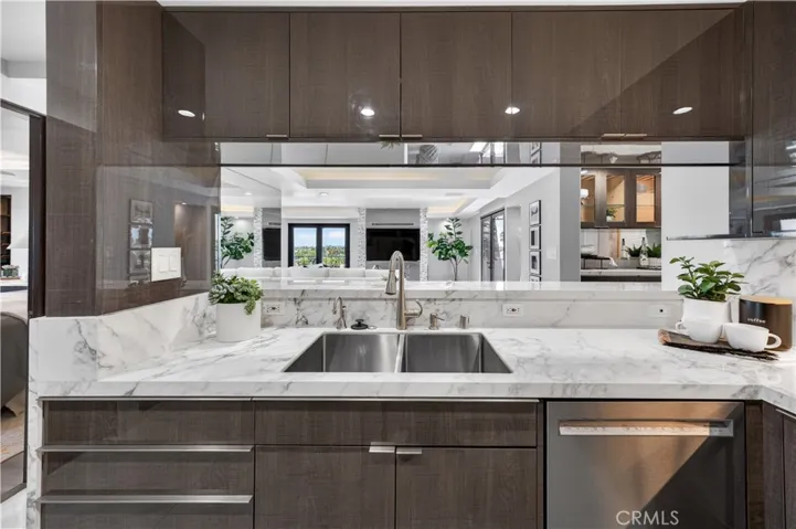 Stainless, double sink and dishwasher make up one side of the kitchen.