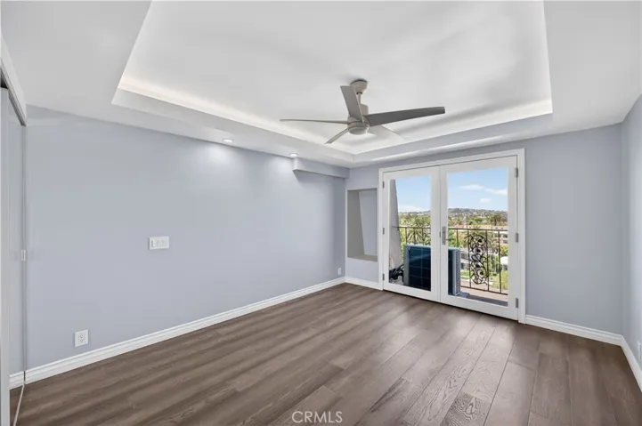 Second bedroom with French doors, architectural ceiling and lovely city views.