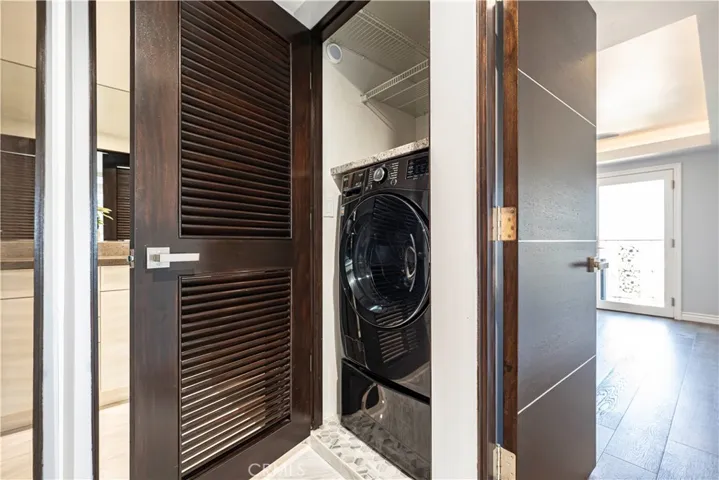 In-unit European washer/dryer is tucked away in the closet alongside the tankless water heater (not pictured).